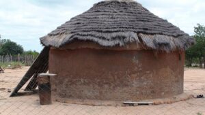 A grass hatched home in Sudan. LazyLawn will work to build more with its addition of grassy areas to the region. 